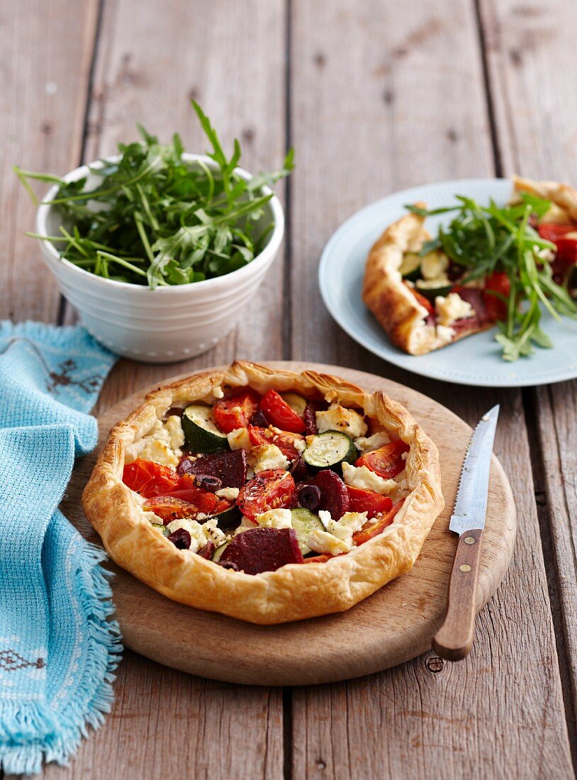 Puff pastry pie with salami, vegetables and feta