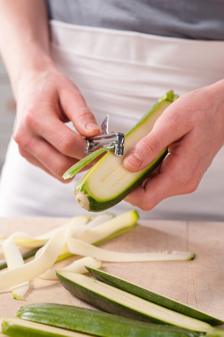 Courgettes being peeled