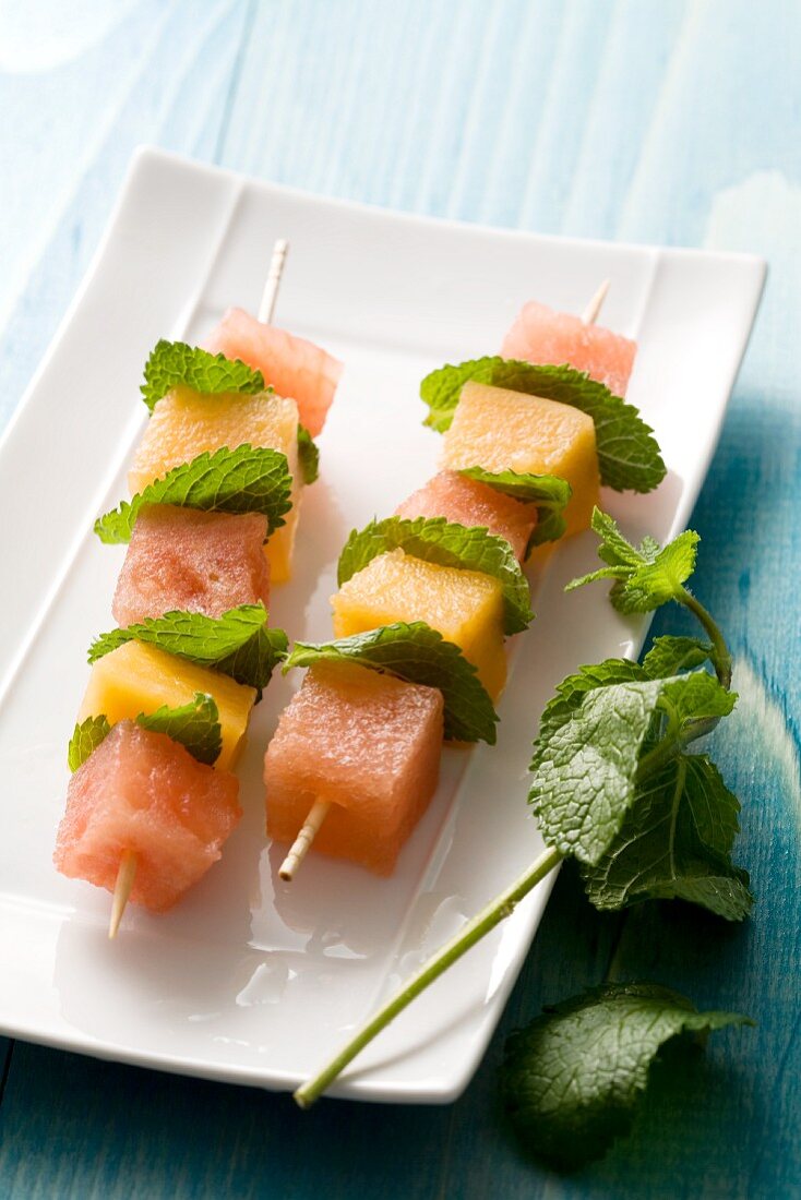 Melon skewers with mint leaves