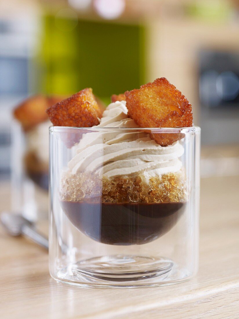 A dessert of coffee granita with chocolate sauce and sweetened cream topping