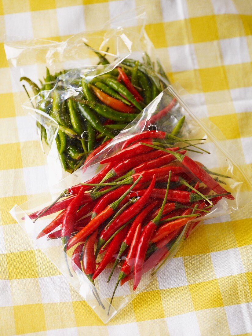 Fresh green and red chillies in bags
