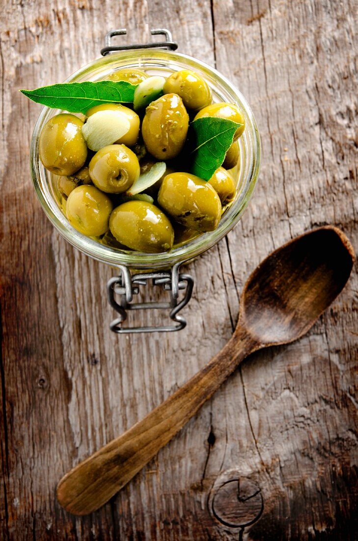 Preserved olives on a wooden surface