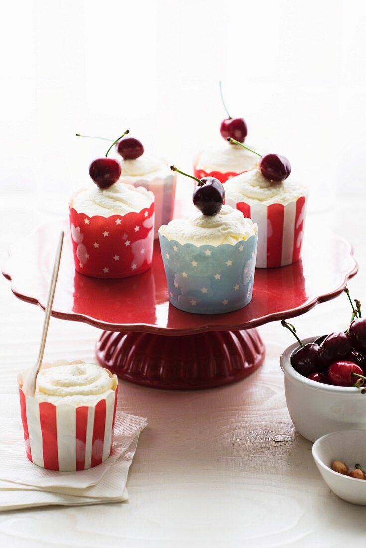 Mousse topped with cherries in small cases