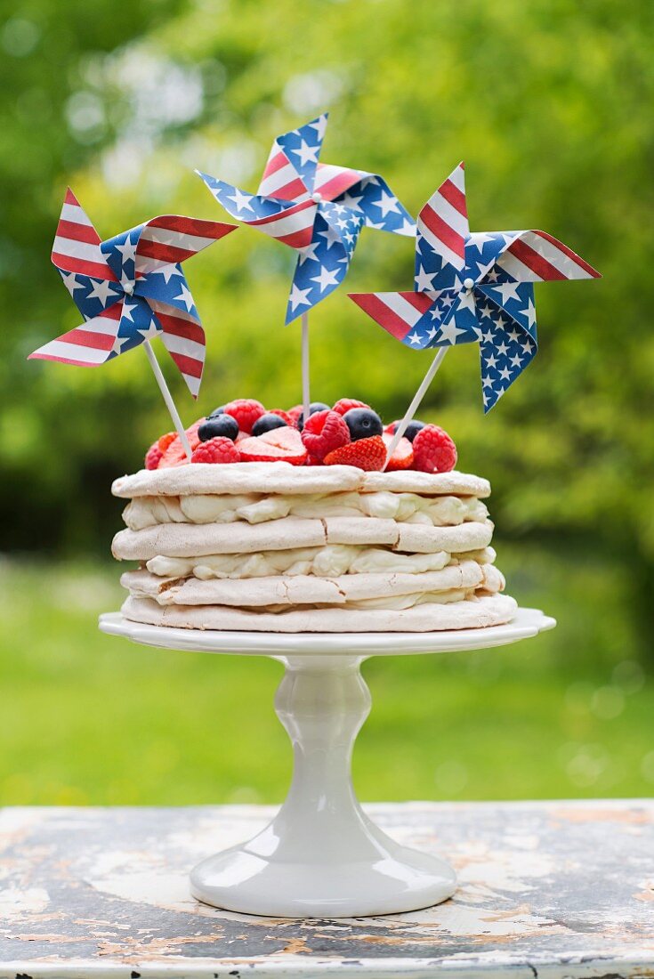 Meringue layer cake with berries and US-flag pinwheels