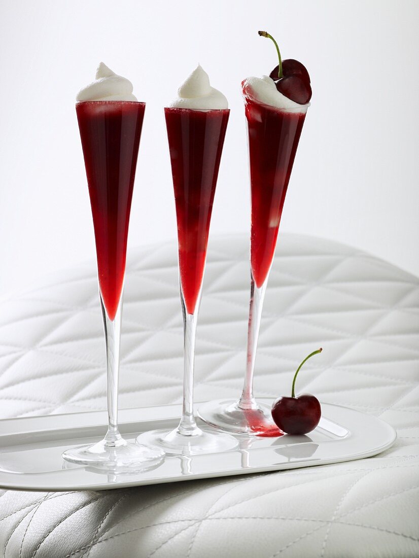 Sweet cherry jelly topped with whipped cream