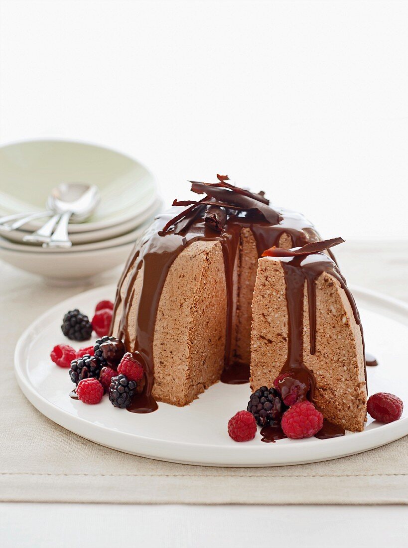 Ice cream bombe with chocolate sauce and fresh berries