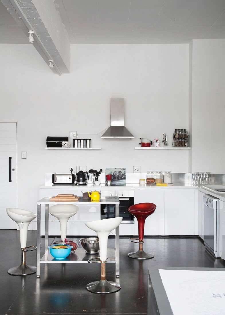 Designer shell barstools at counter-style table in minimalist kitchen