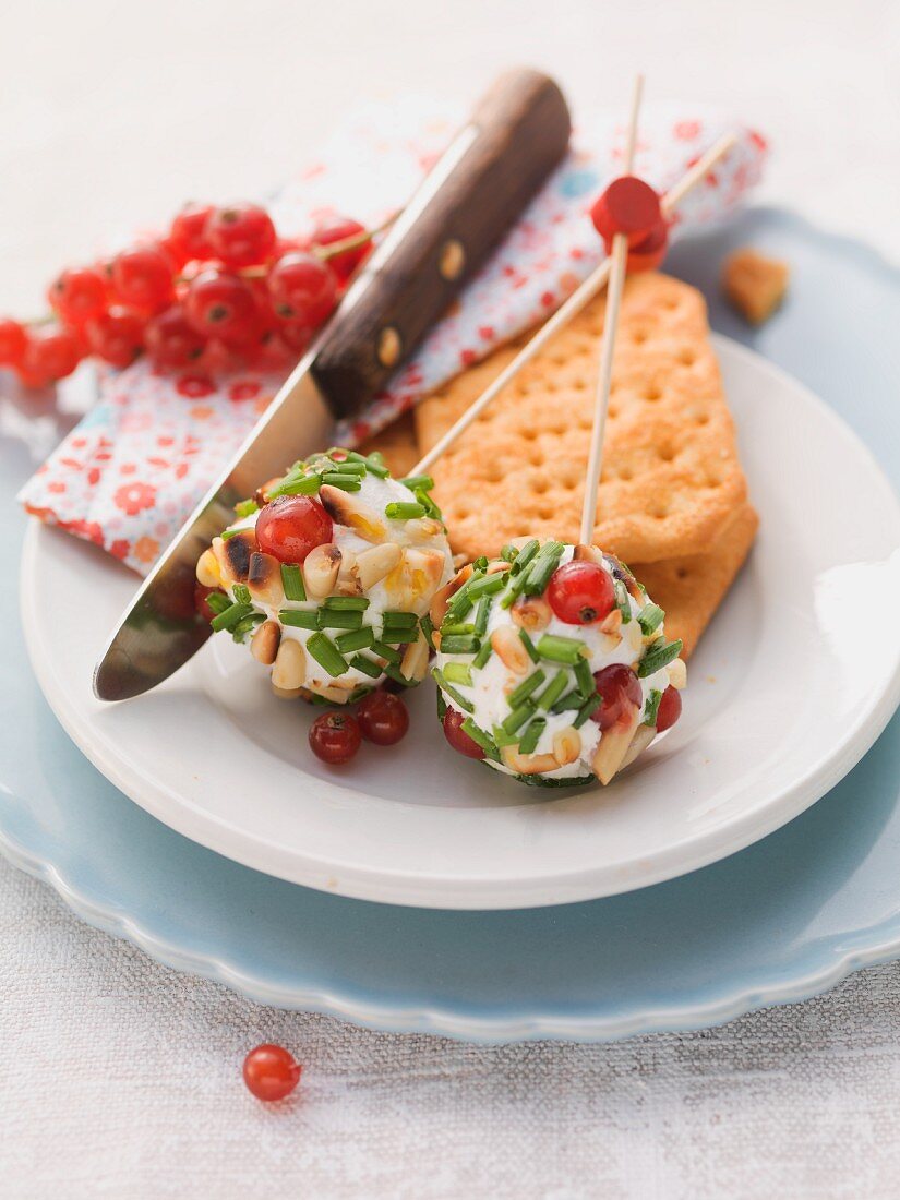Cream cheese balls on skewers with redcurrants