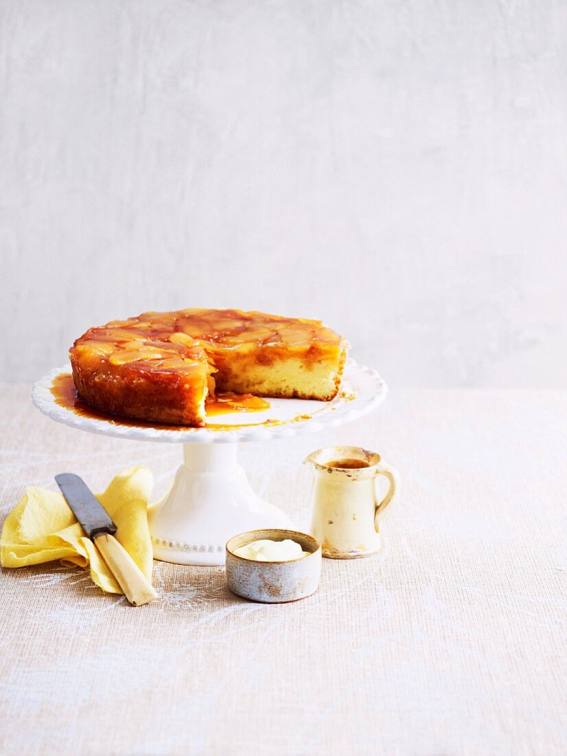 Apple upside-down cake on a cake stand