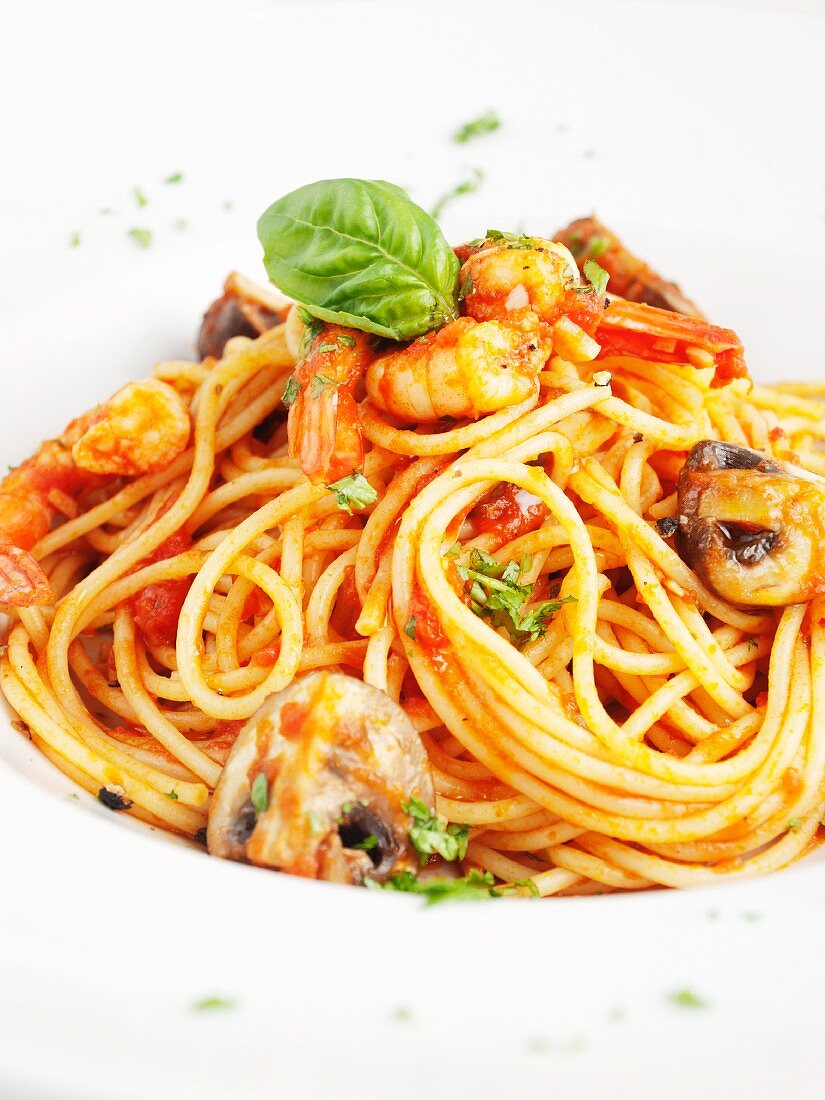 Spaghetti arrabbiata with mushrooms and prawns (close-up)