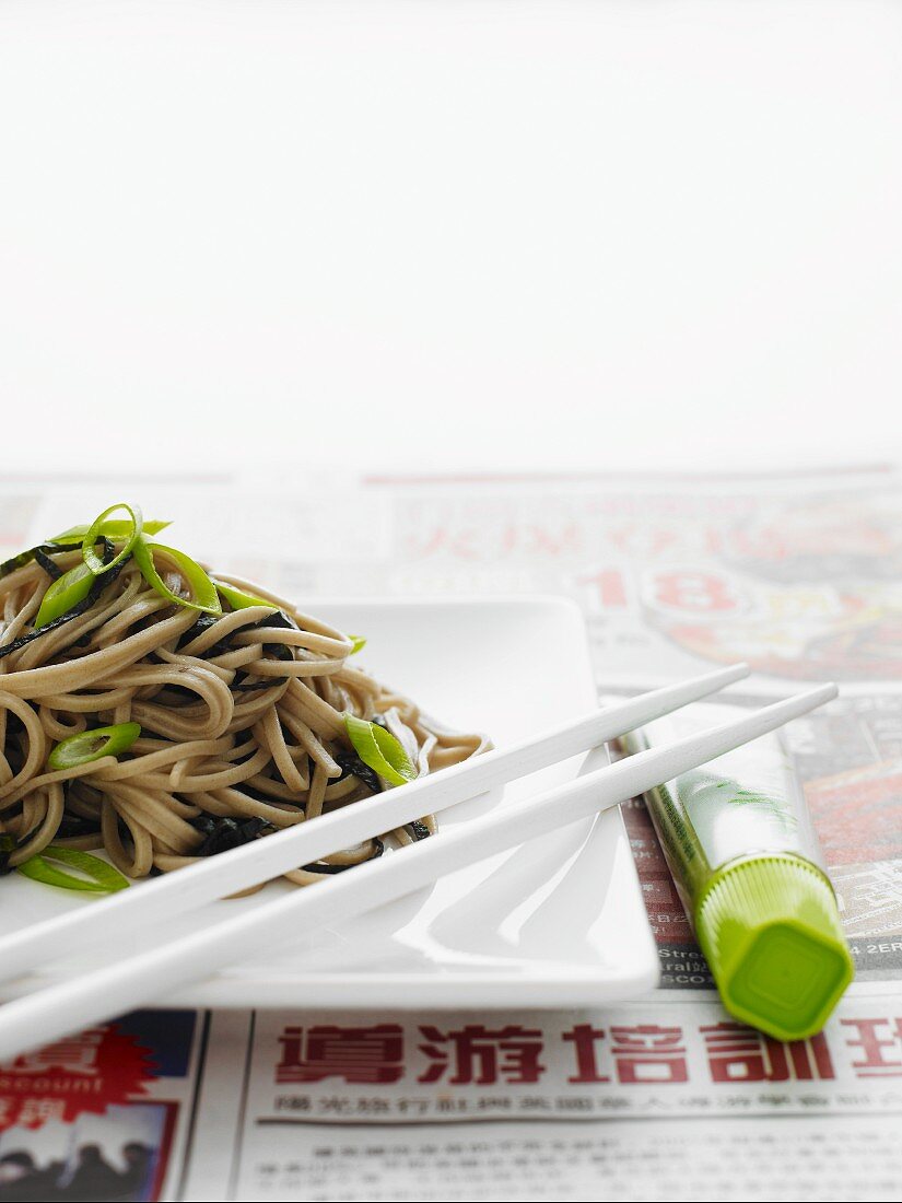 Japanese soba noodles on a white plate with white chopsticks