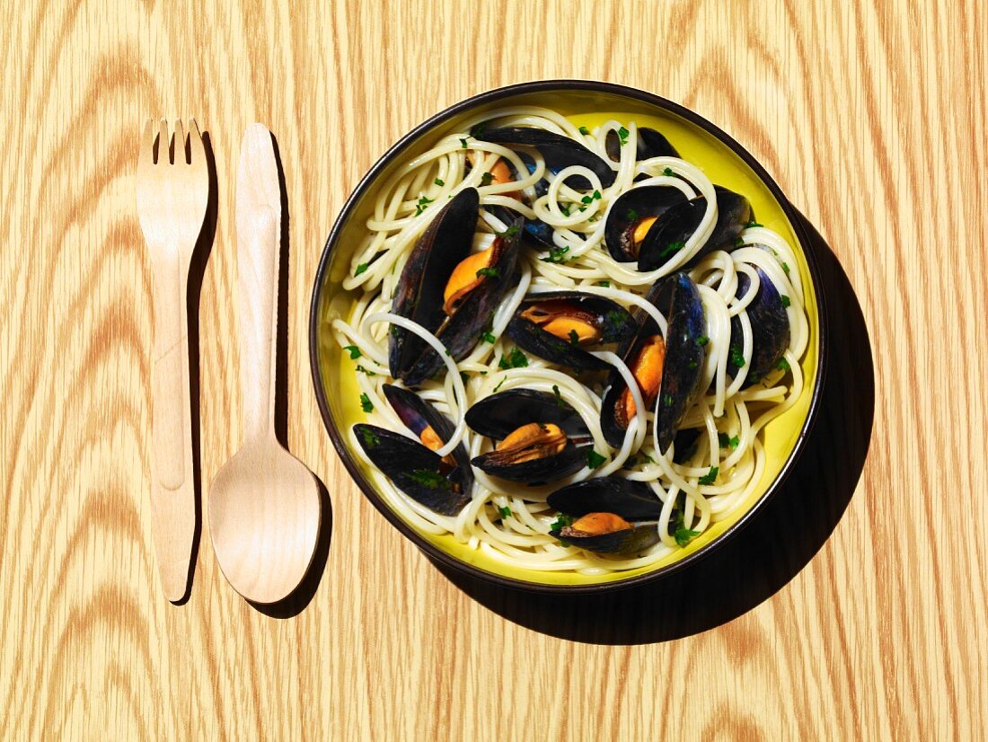 A bowl of cooked mussels with spaghetti