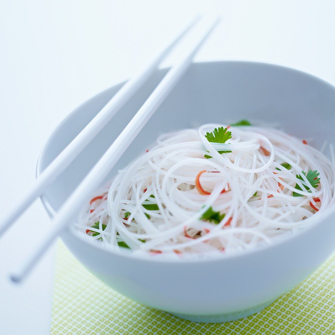 Glass noodles with chilli and coriander in a white bowl