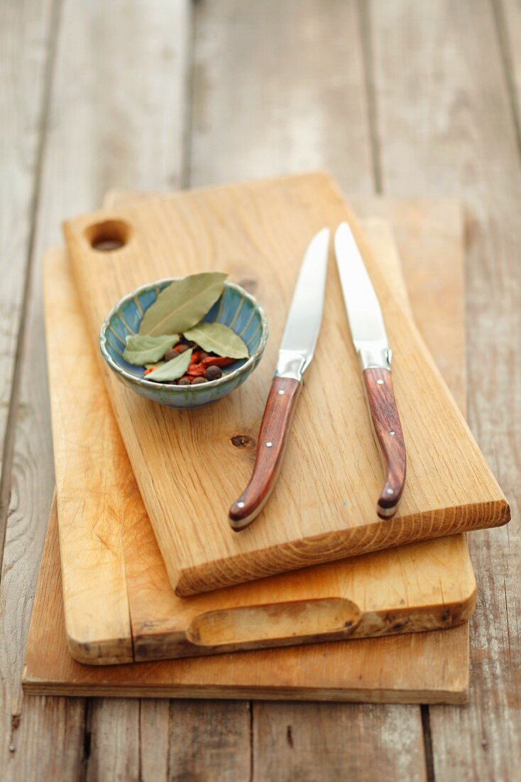 Wooden boards, knives and a small dish of spices