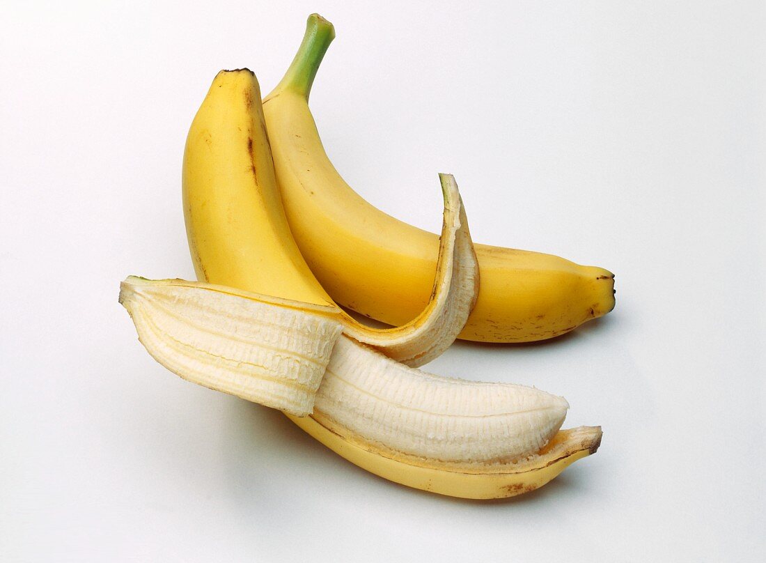 Two Bananas; One Partially Peeled