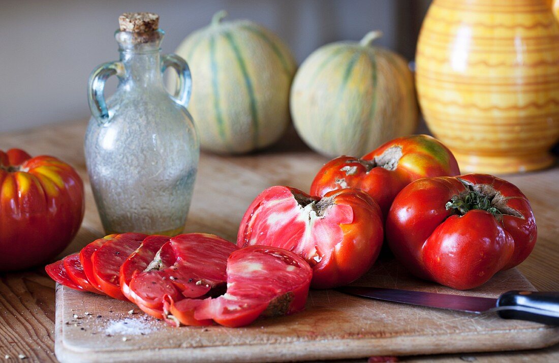 Oxheart tomatoes, one partly sliced