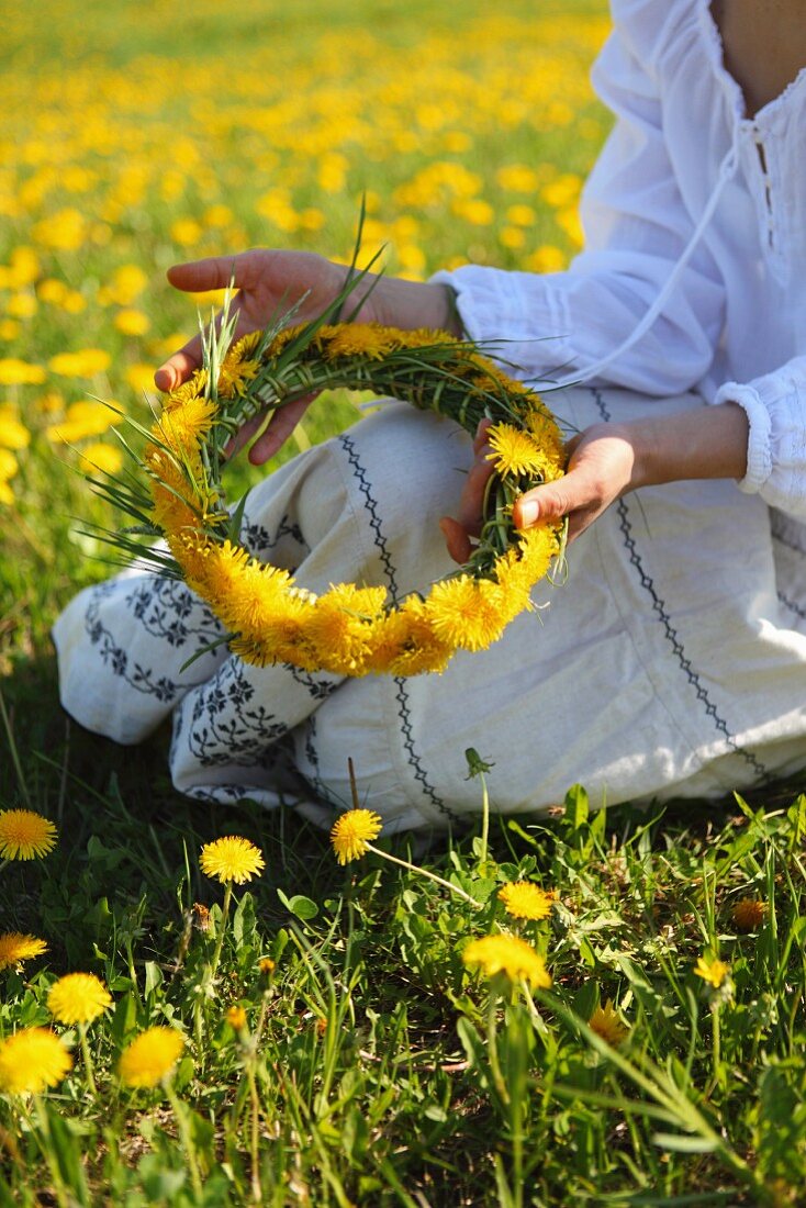 Woman making dandelion wreath