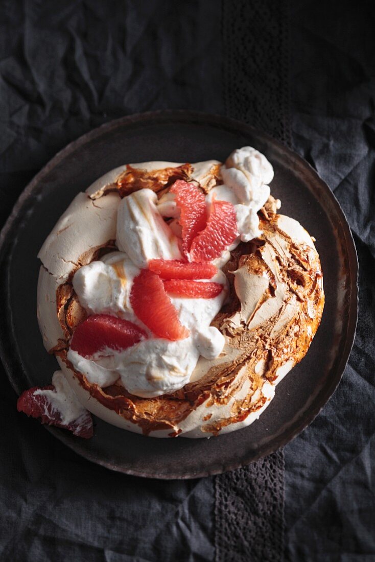 Caramel pavlova with vanilla-rum cream and marinated grapefruit