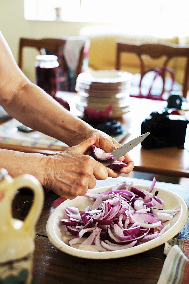 Red onions being cut into small pieces