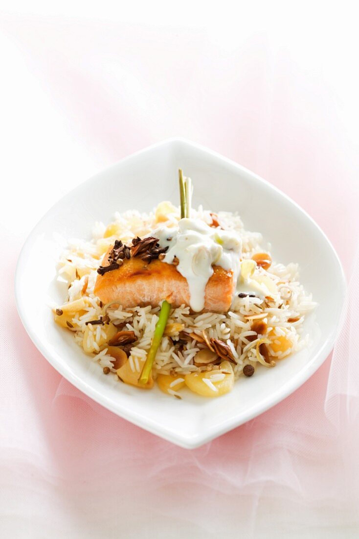 Salmon fillet with cream sauce on spiced rice