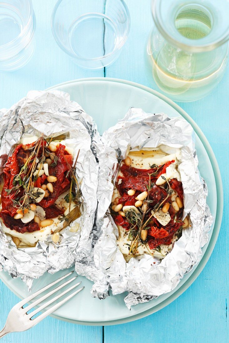 Feta with dried tomatoes, garlic and thyme grilled in foil