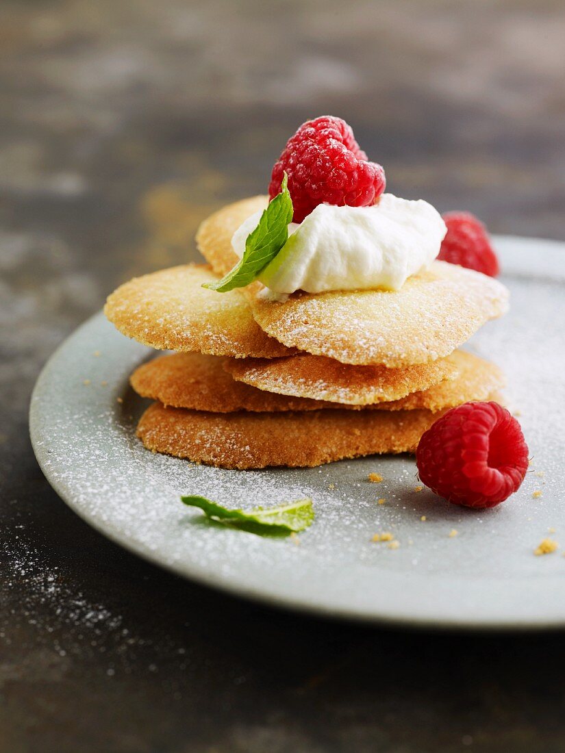 Langues de chat with whipped cream and raspberries
