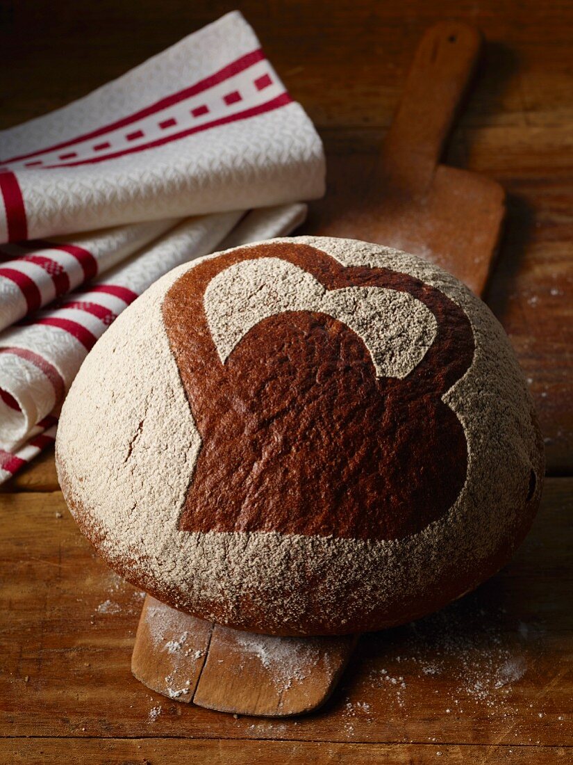 A bread roll decorated with a heart design