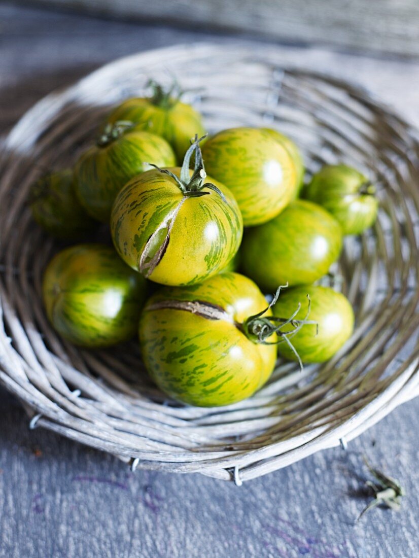 Green zebra tomatoes in a wicker basket