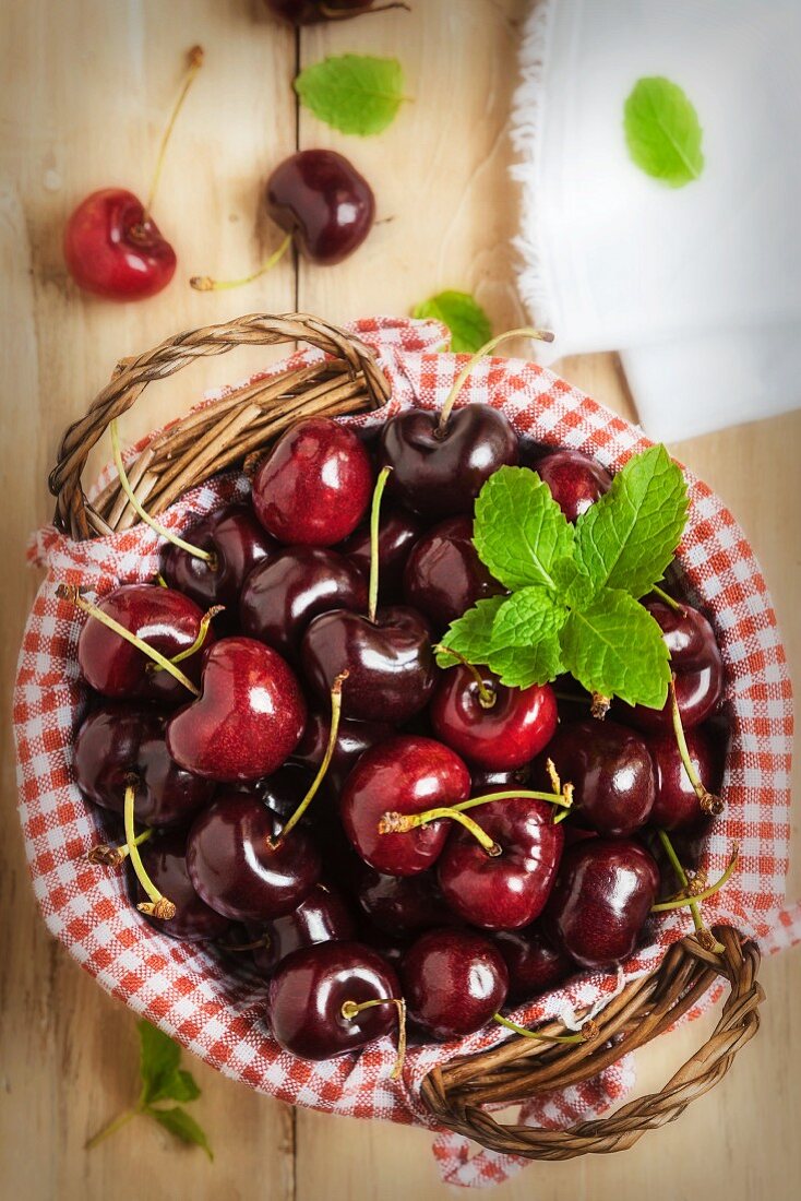 A Basket of Fresh Cherries with Mint