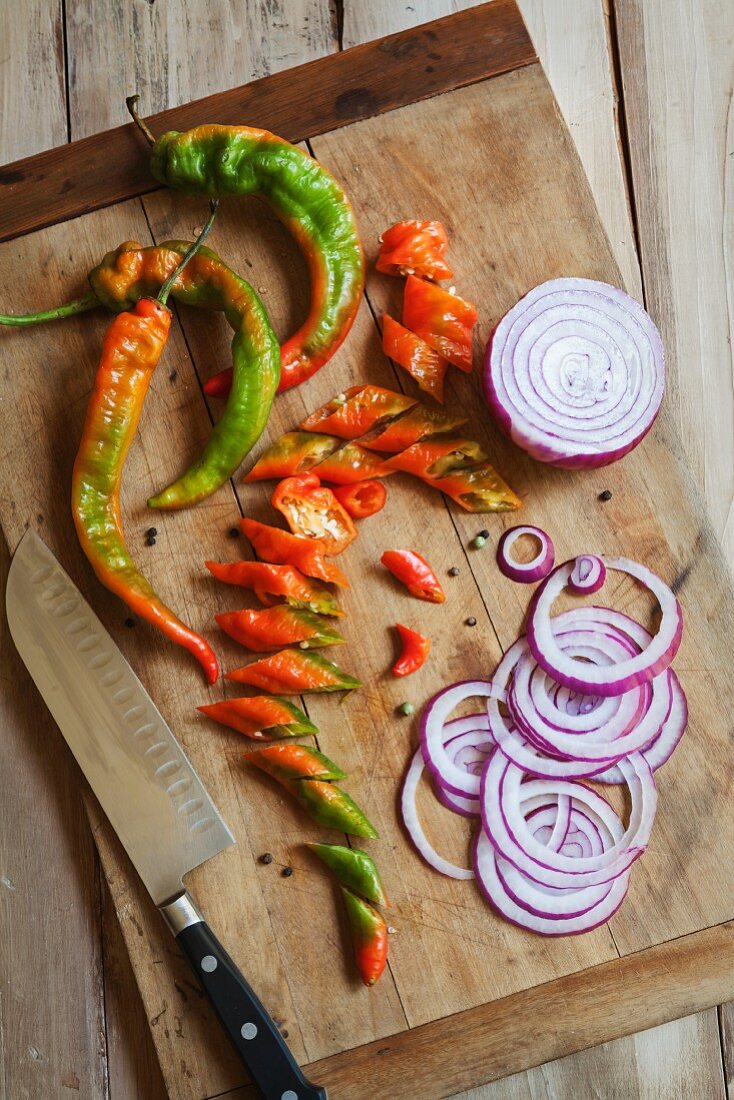 Long Hot Peppers with Onions Sliced on a Cutting Board