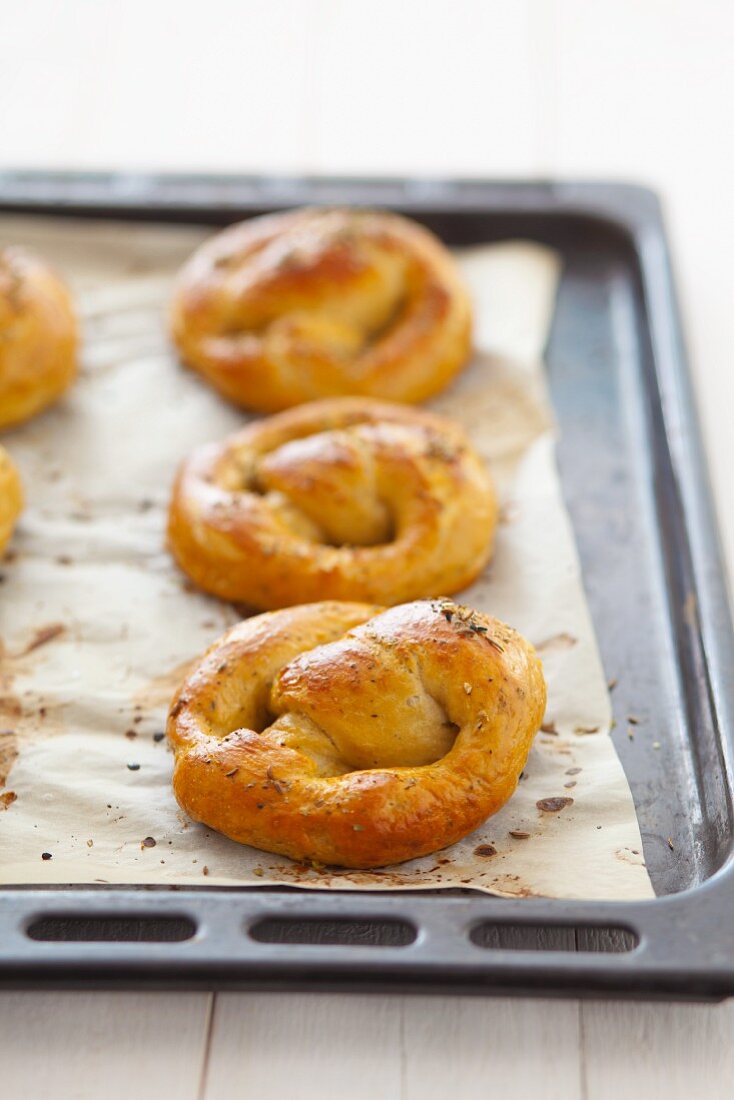 Freshly baked yeast pretzels on a baking tray