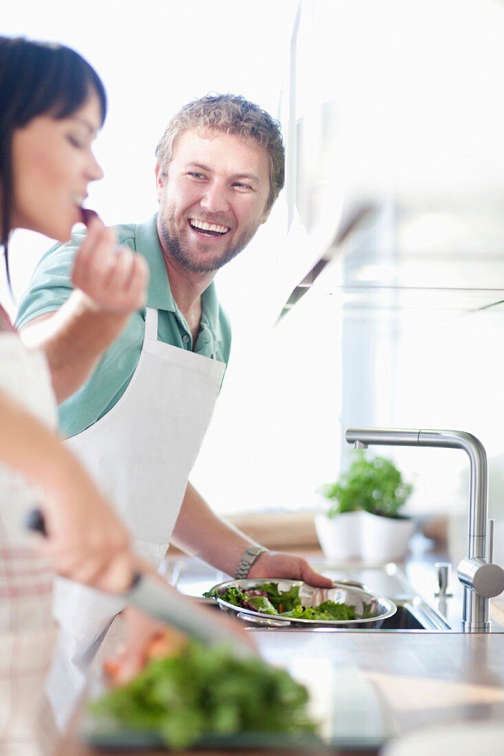 A couple cooking together in the kitchen