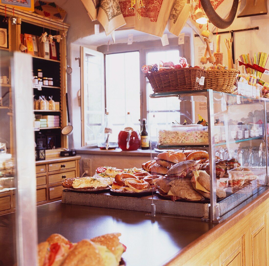 A rustically furnished shop floor with baked goods and other items for sale