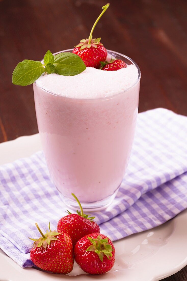 A milkshake with fresh strawberries