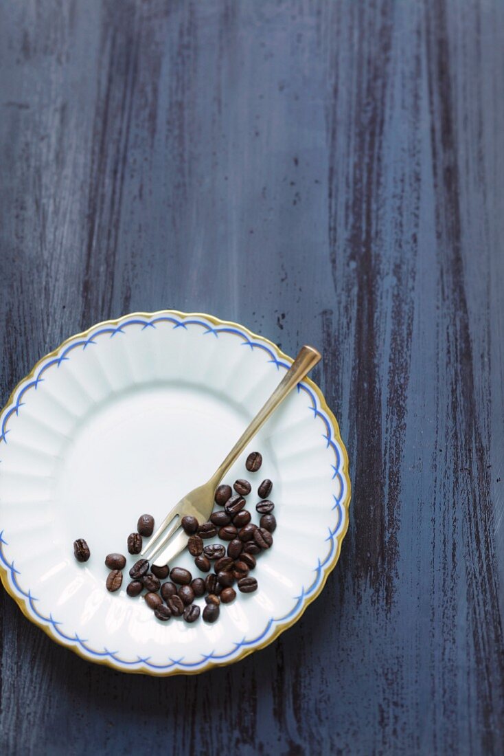 Coffee beans on a plate with a fork