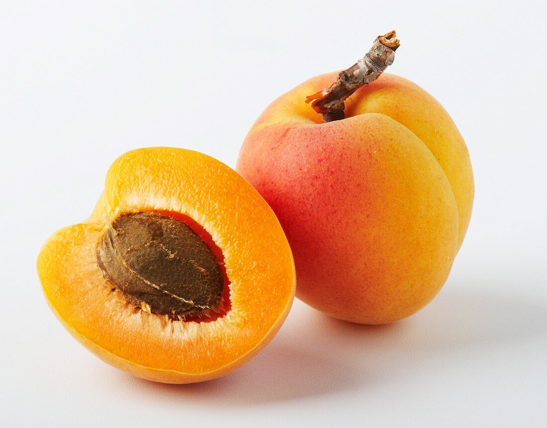 One half and one whole apricot