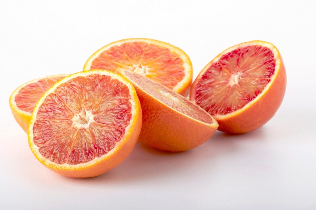 Five blood orange halves