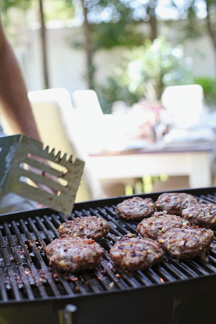 Meat patties on a barbecue