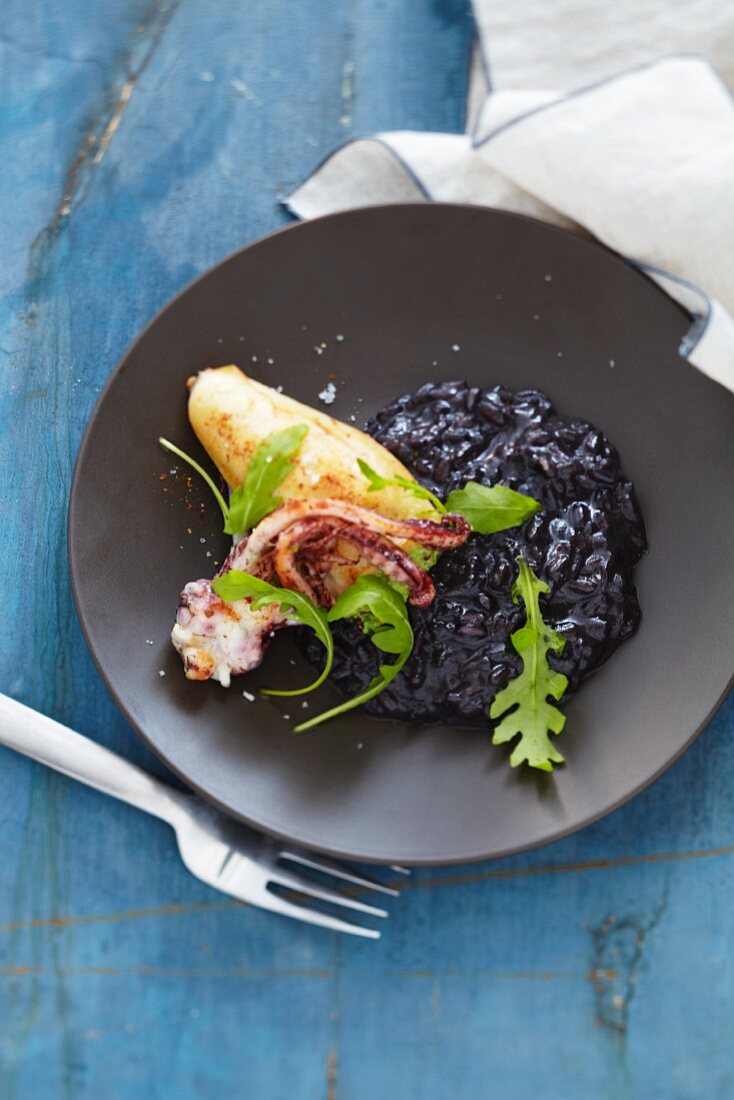 Stuffed squid on a bed of black risotto