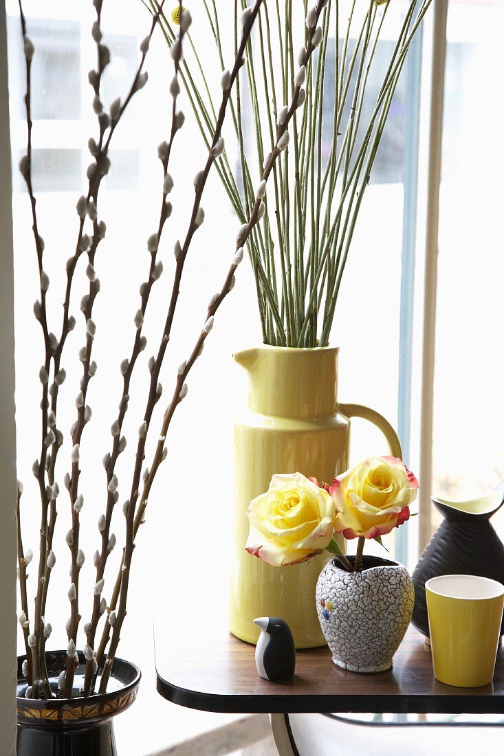 Pussy willow, yellow roses, vase and penguin ornament