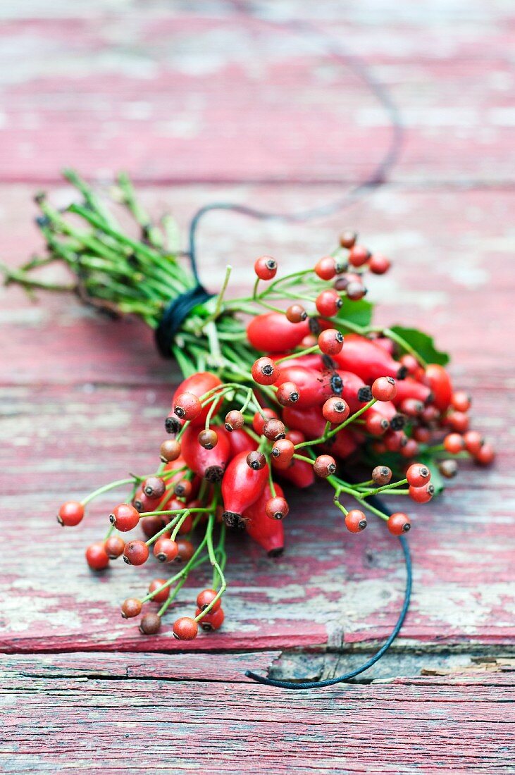 A bouquet of hawthorn berries on weathered wood