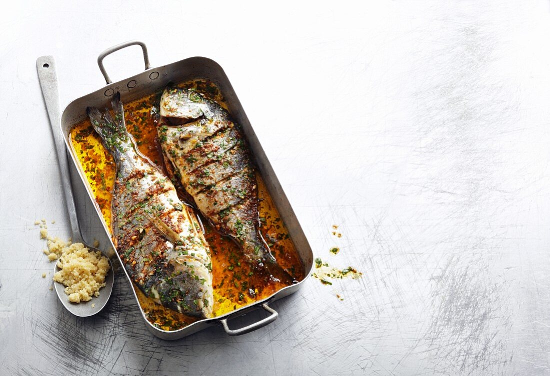 Gilt-head bream baked in spiced oil