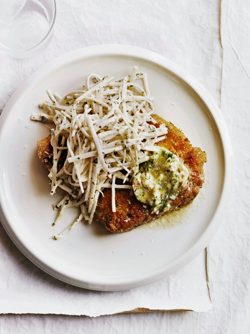 Crumbed pork chops with anchovy butter and celeriac chilli remoulade