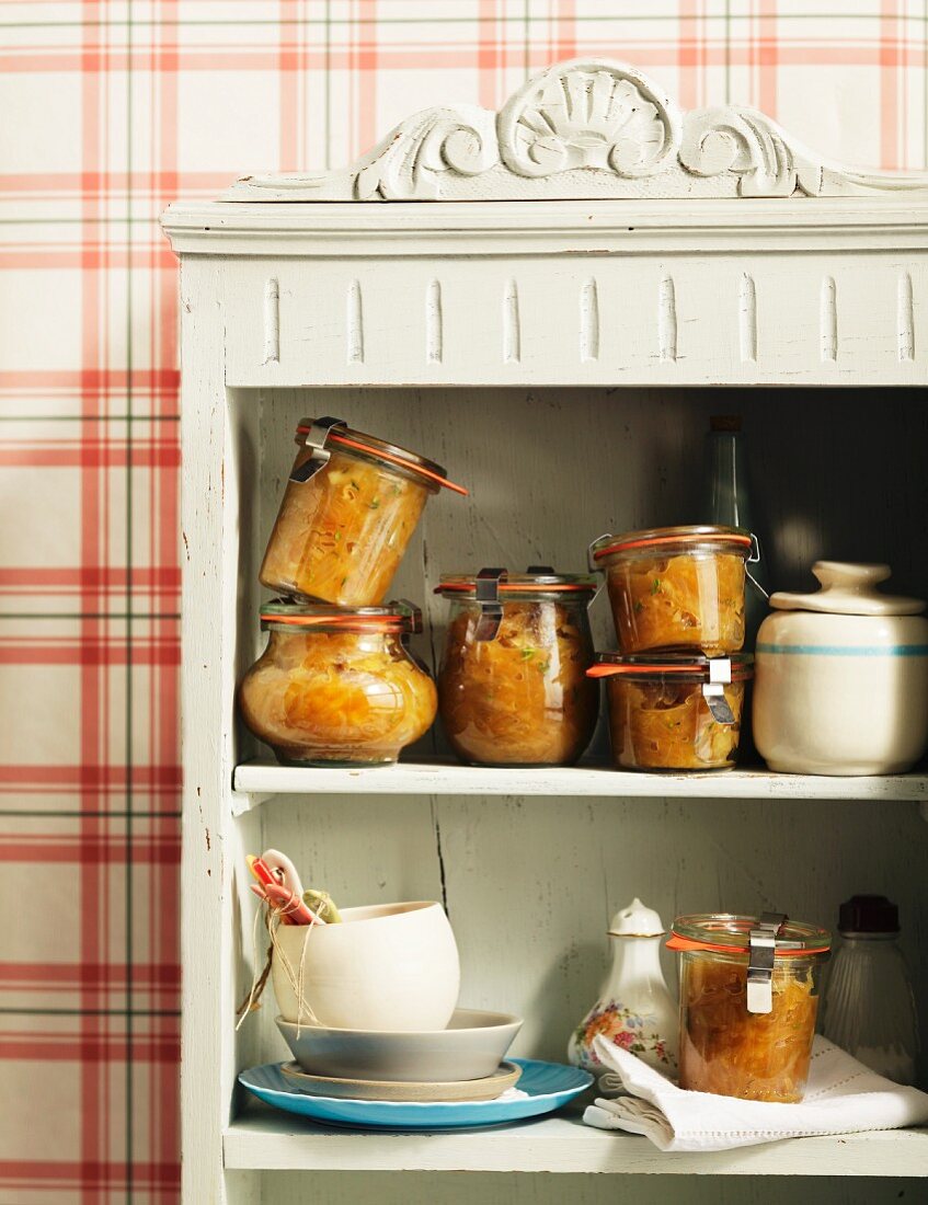 Caramelised onion chutney with thyme in a kitchen cupboard