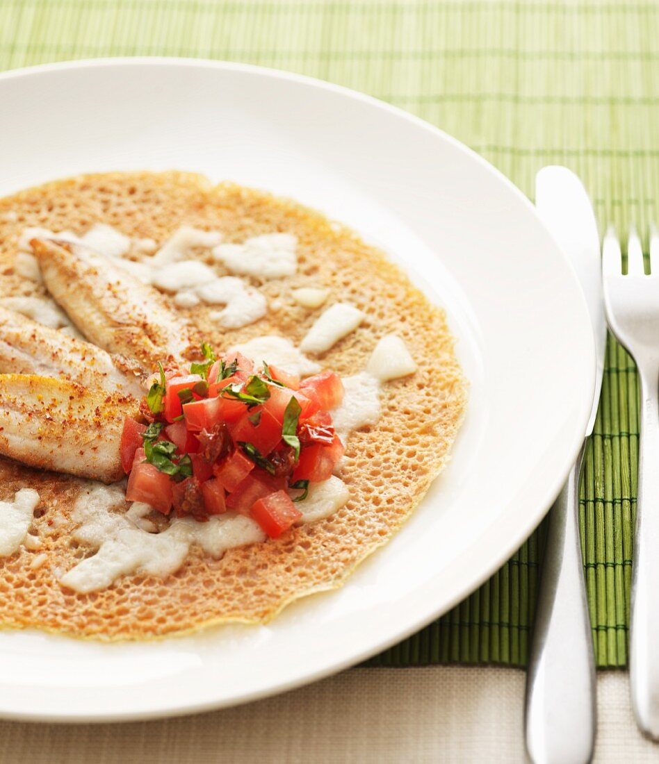 Buckwheat pancakes with sardines, tomatoes and parmesan