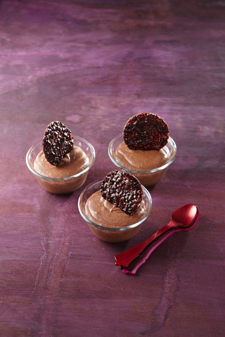 Three miniature dessert bowls of mousse au chocolat