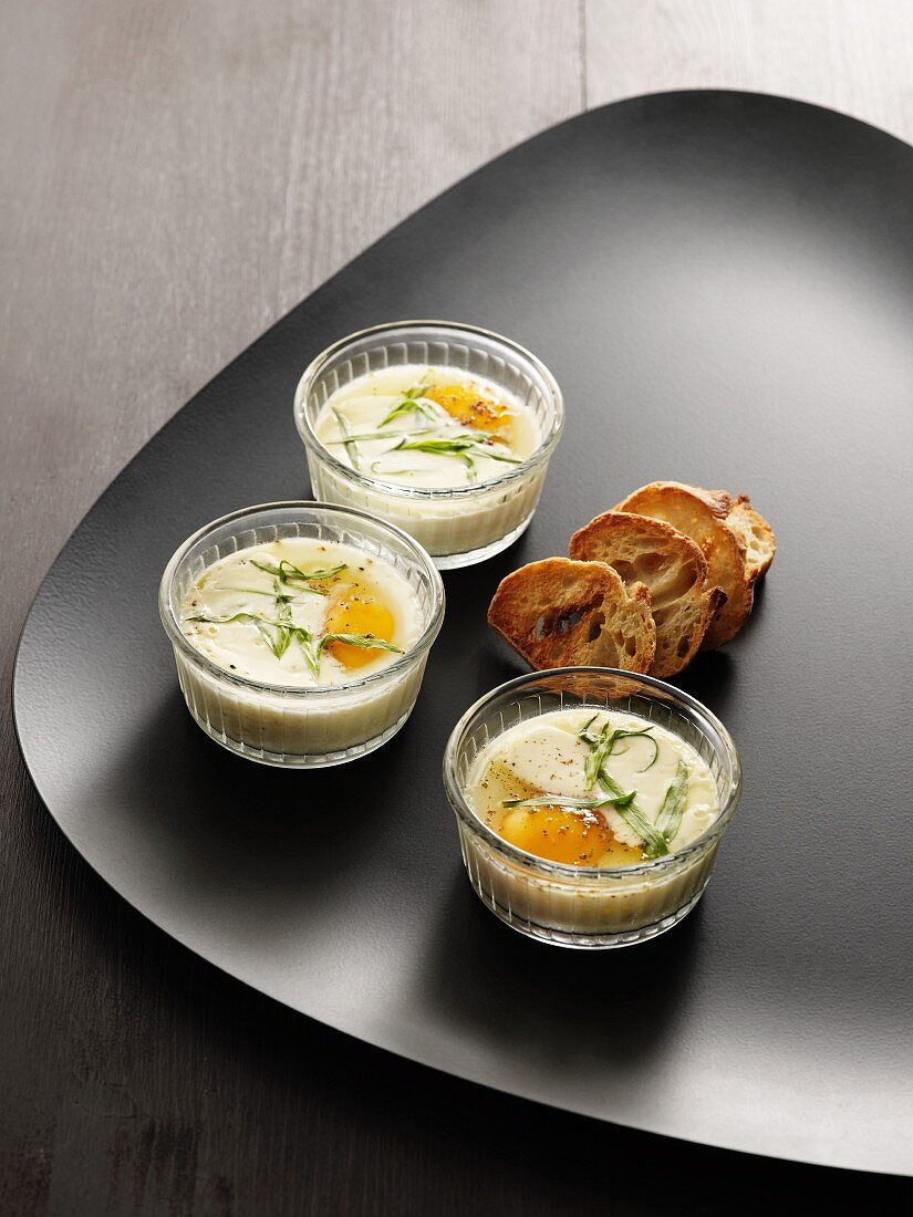 Oeufs en cocotte (baked eggs, France) with chervil and toasted slices of bread