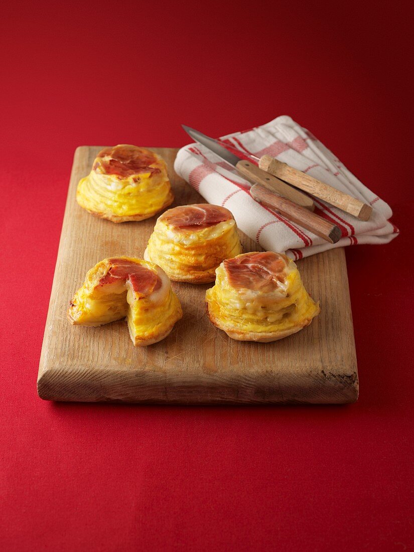 Small upside-down potato muffins with bacon on a wooden board