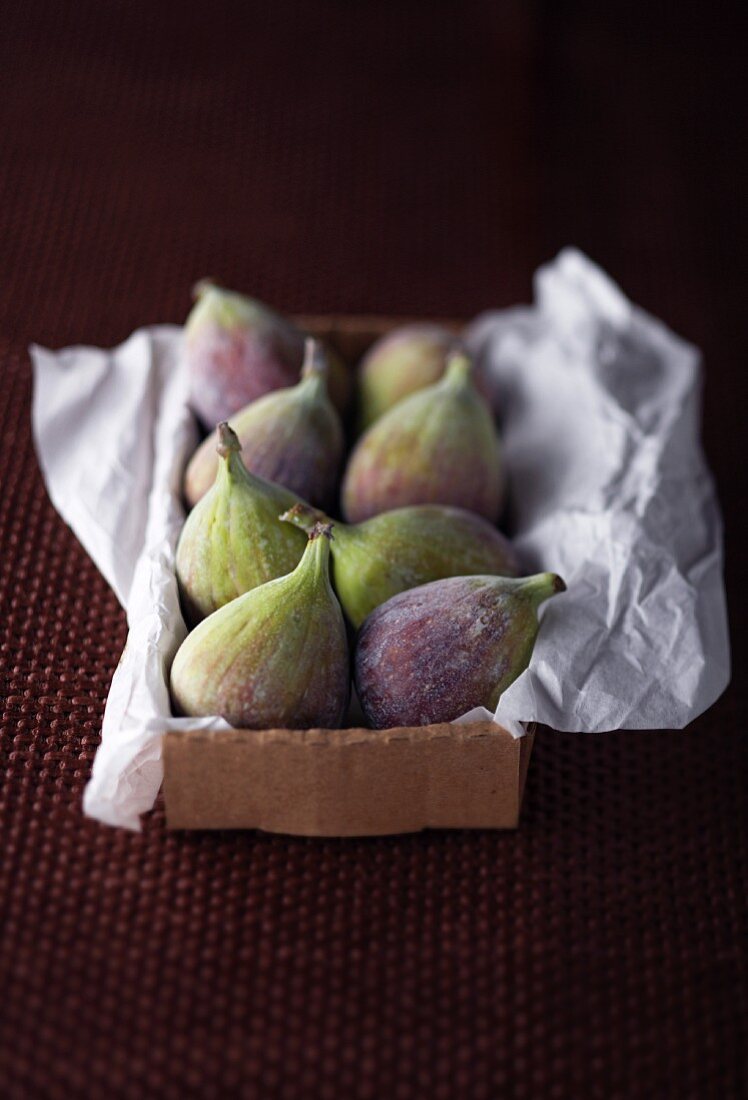 Fresh figs on paper in a box