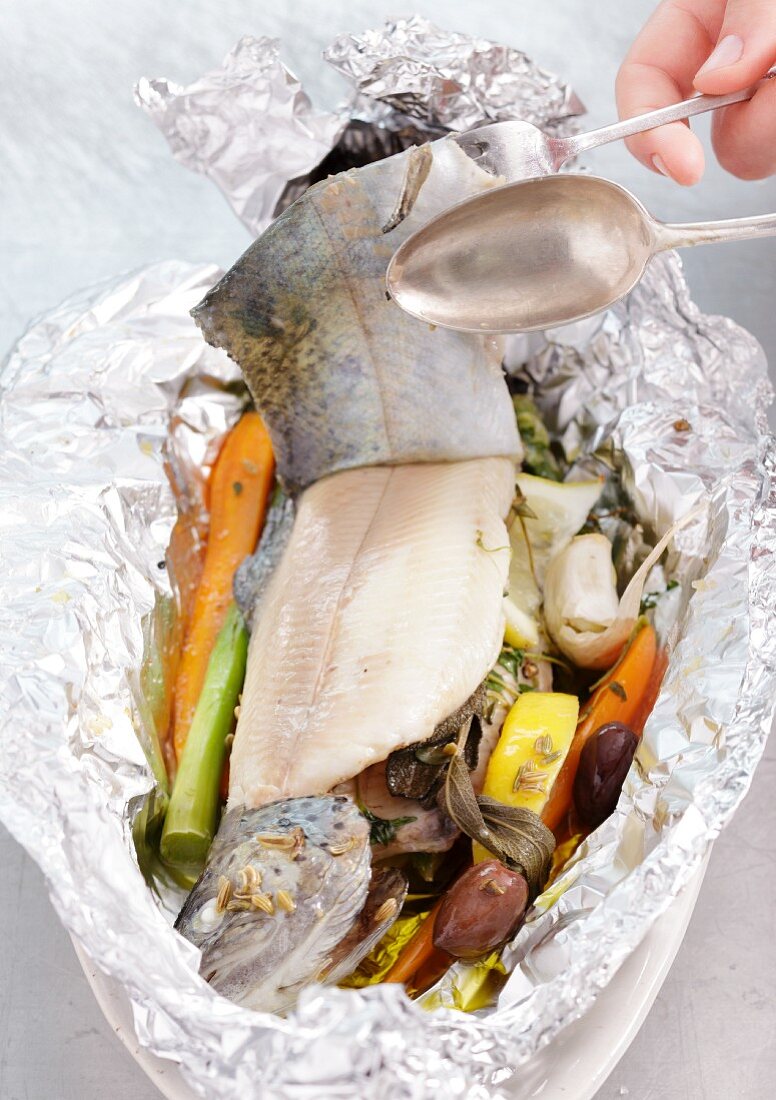 Trout with vegetables, wrapped in foil